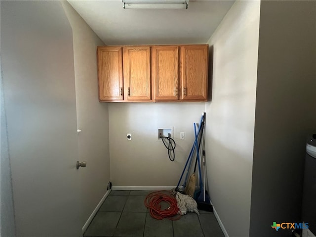 clothes washing area featuring dark tile patterned floors, washer hookup, cabinets, and hookup for an electric dryer