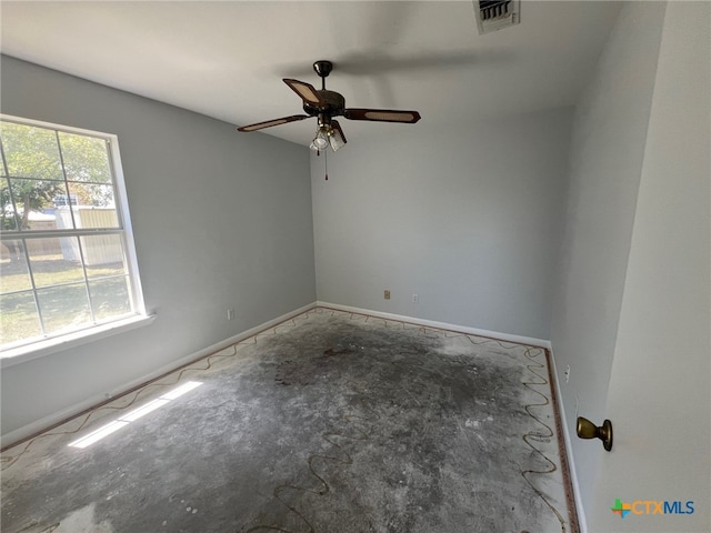 spare room with a wealth of natural light and ceiling fan