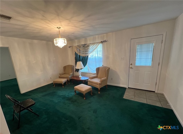 unfurnished room featuring a chandelier and carpet