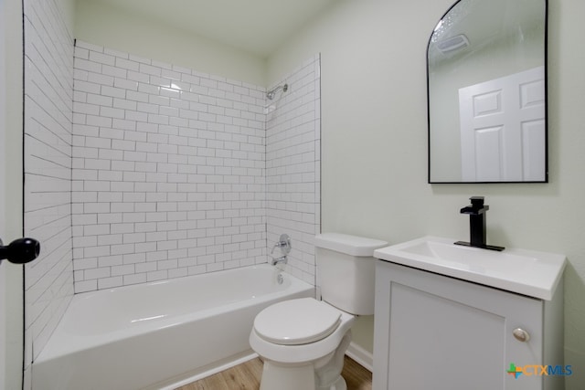 full bathroom with wood-type flooring, vanity, toilet, and tiled shower / bath combo