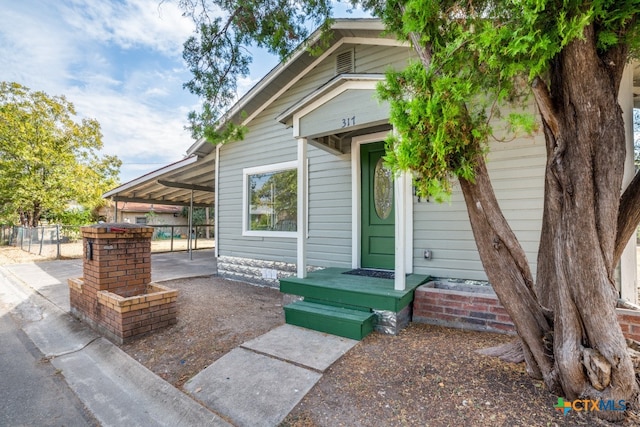 view of exterior entry featuring a carport