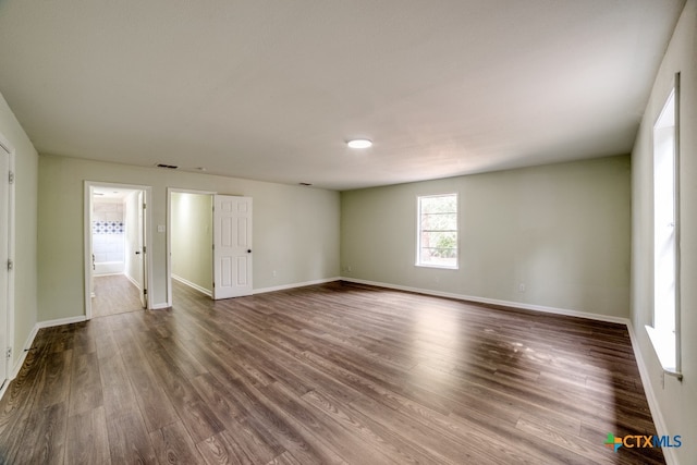 unfurnished room featuring dark hardwood / wood-style flooring