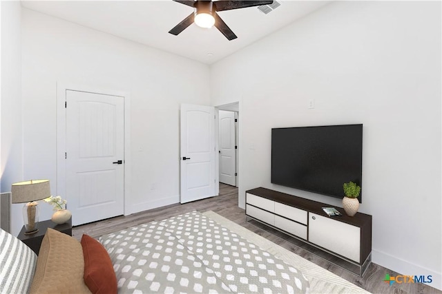 bedroom featuring vaulted ceiling, ceiling fan, and dark hardwood / wood-style floors