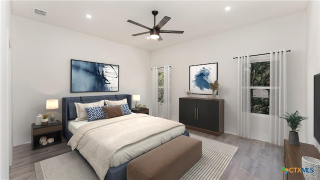 bedroom with ceiling fan and hardwood / wood-style flooring