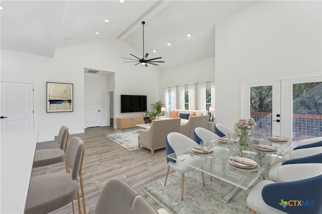 dining space with light hardwood / wood-style floors, french doors, high vaulted ceiling, beam ceiling, and ceiling fan