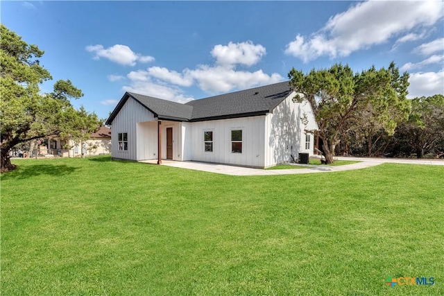 rear view of house featuring a yard and a patio area