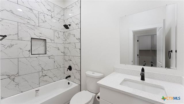 full bathroom with toilet, tiled shower / bath combo, and vanity