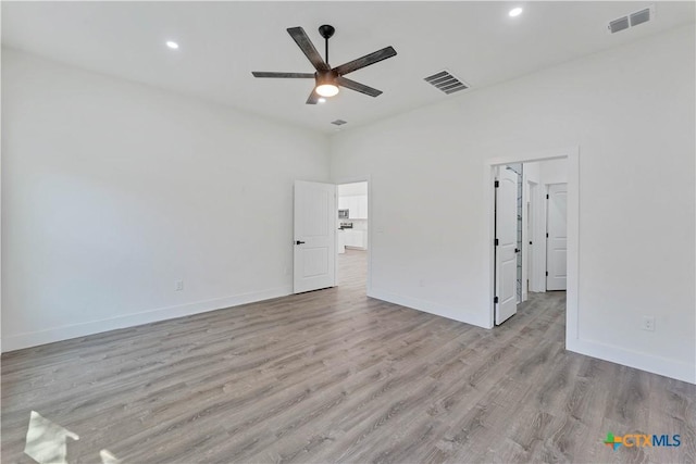 empty room featuring light wood-type flooring and ceiling fan