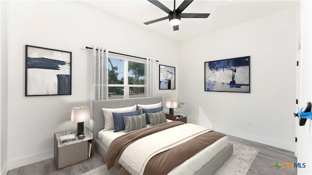 bedroom with ceiling fan and light hardwood / wood-style flooring