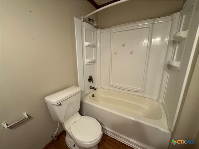 bathroom with wood-type flooring, toilet, and shower / washtub combination