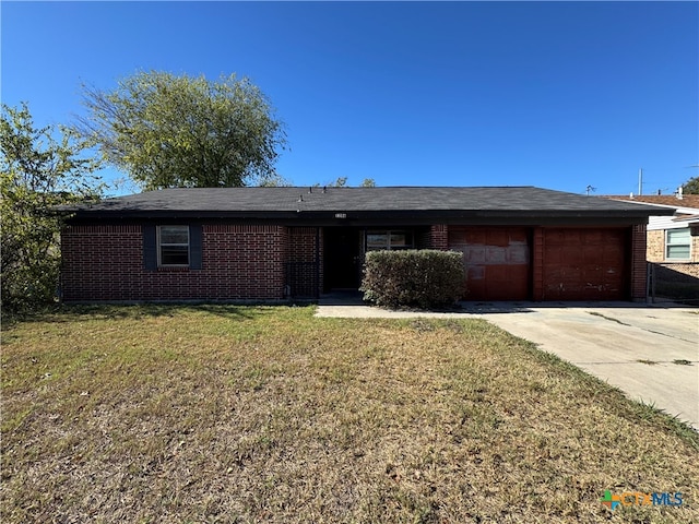 single story home with a garage and a front lawn