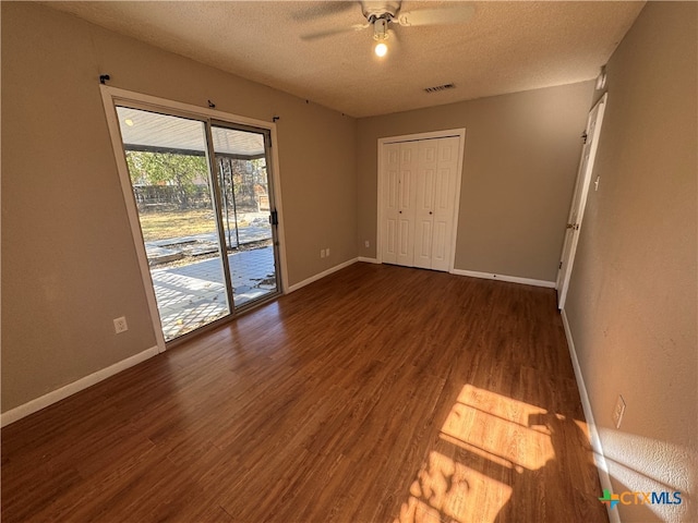 spare room featuring hardwood / wood-style floors, ceiling fan, and a textured ceiling