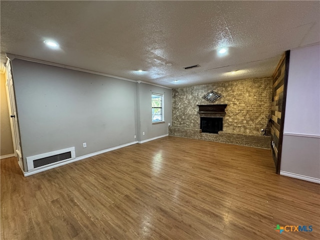 unfurnished living room featuring wood-type flooring and a textured ceiling