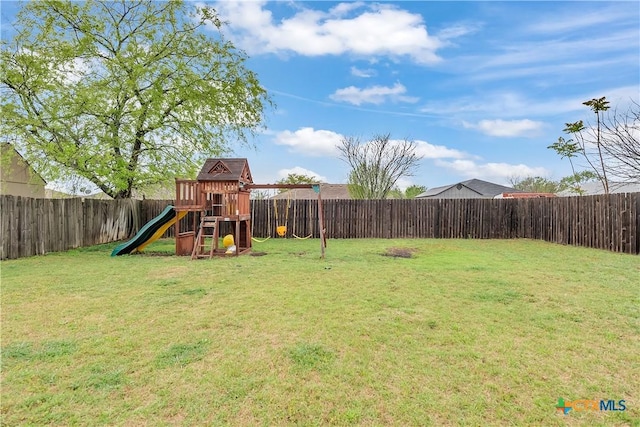 view of yard featuring a fenced backyard and a playground
