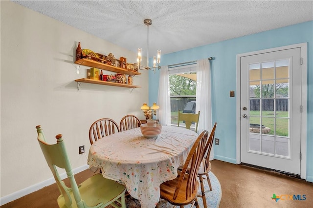 dining room with baseboards, a chandelier, and a textured ceiling