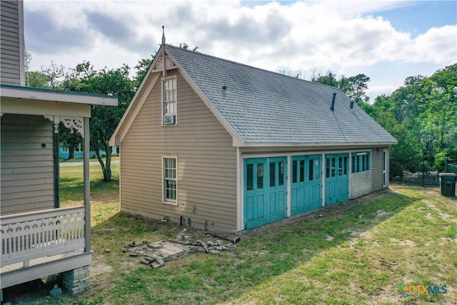 view of property exterior featuring a yard and a shingled roof