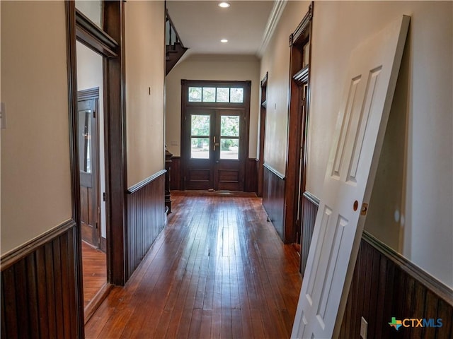 entryway with recessed lighting, dark wood-style floors, ornamental molding, french doors, and wainscoting