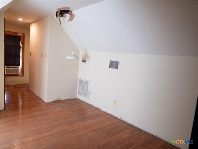additional living space featuring recessed lighting, light wood-style flooring, visible vents, and cooling unit