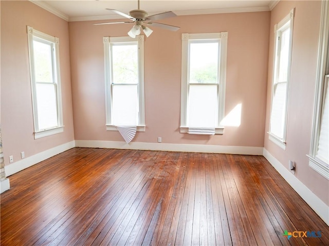 spare room featuring hardwood / wood-style floors, plenty of natural light, ceiling fan, and crown molding
