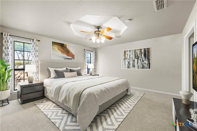 carpeted bedroom with a textured ceiling and ceiling fan