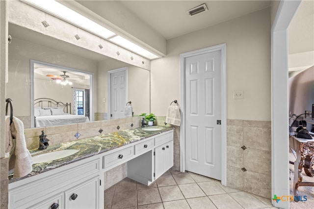 bathroom with ceiling fan, tile patterned floors, and vanity