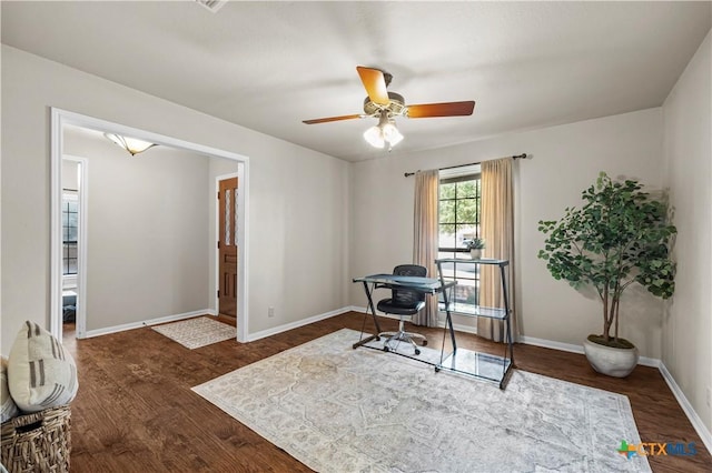 home office featuring dark wood-type flooring and ceiling fan