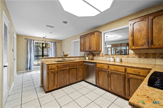 kitchen with dishwasher, kitchen peninsula, sink, an inviting chandelier, and decorative light fixtures