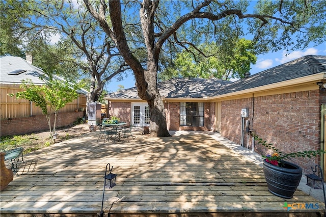 rear view of house featuring a wooden deck