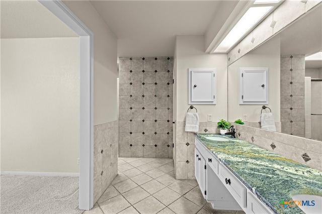 bathroom with tile patterned floors, vanity, and tile walls