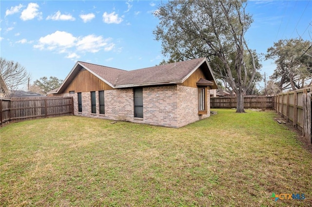 rear view of property with a yard