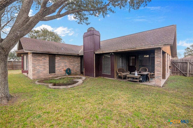 rear view of property with a patio area and a lawn