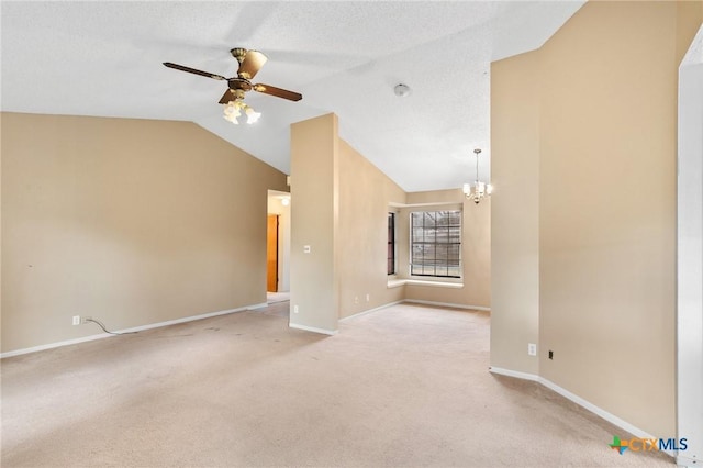 unfurnished living room featuring ceiling fan with notable chandelier, vaulted ceiling, light colored carpet, and a textured ceiling