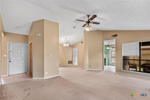 unfurnished living room featuring vaulted ceiling, ceiling fan with notable chandelier, light carpet, and a textured ceiling