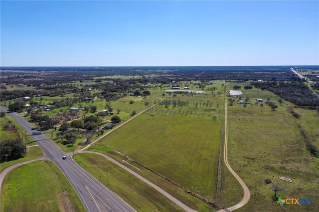 birds eye view of property with a rural view