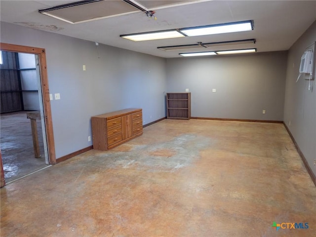 unfurnished room featuring baseboards and concrete floors