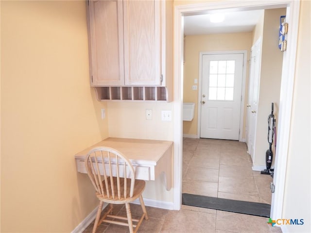 interior space with light tile patterned floors and baseboards