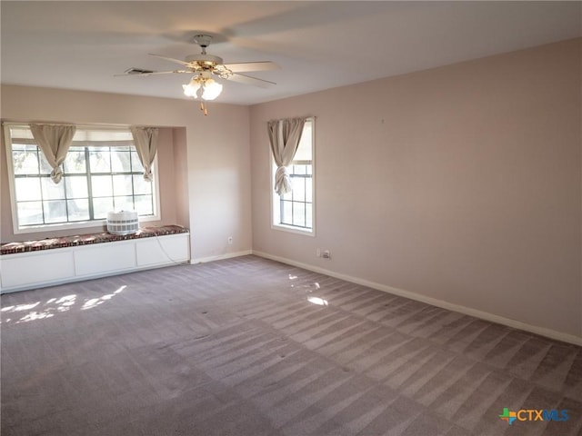 carpeted spare room with baseboards and ceiling fan