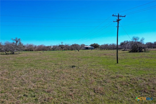 view of yard with a rural view