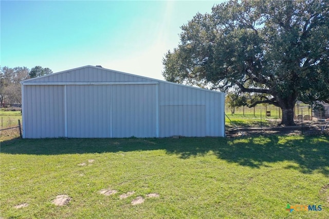 exterior space featuring a lawn and fence