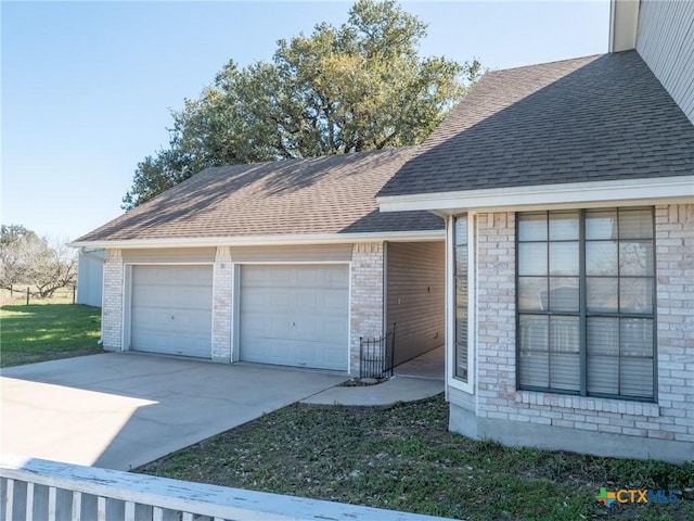 garage featuring driveway