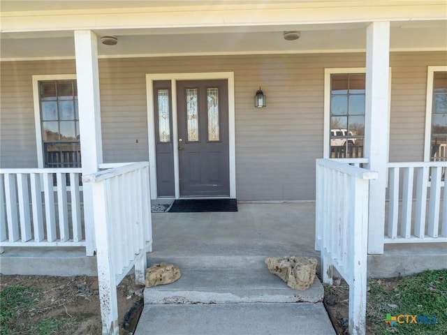 doorway to property featuring covered porch