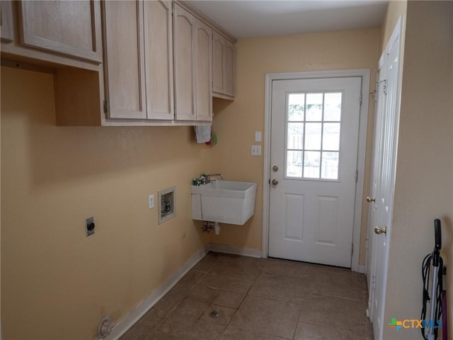 laundry room with electric dryer hookup, a sink, cabinet space, baseboards, and hookup for a washing machine