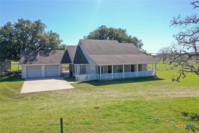 country-style home featuring covered porch, an attached garage, concrete driveway, and a front lawn