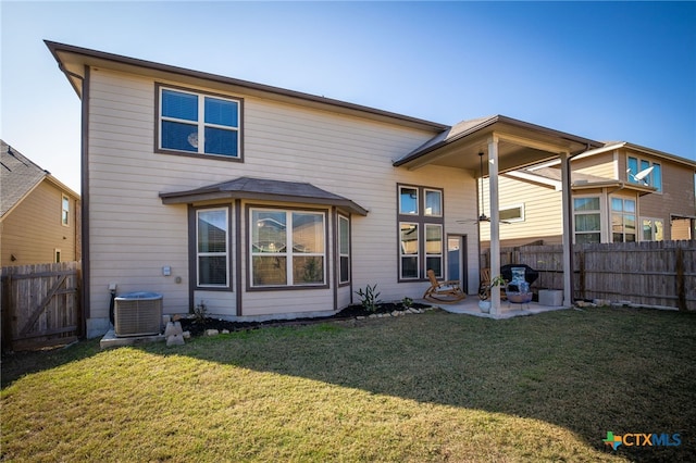 back of property featuring cooling unit, a yard, and a patio