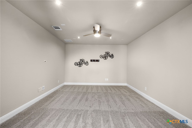 carpeted spare room featuring ceiling fan