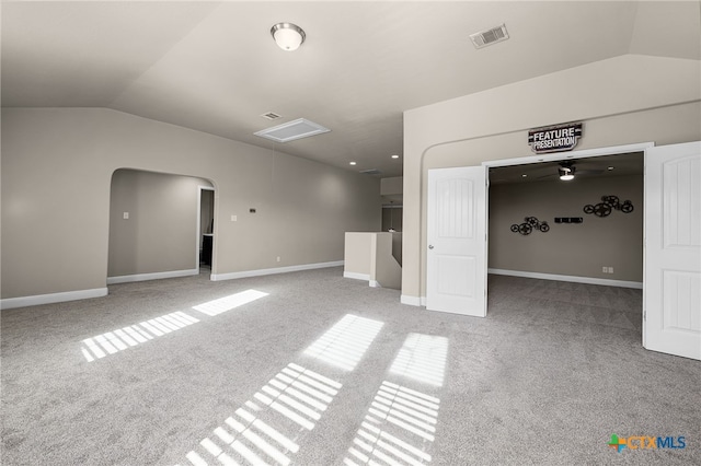 carpeted empty room featuring ceiling fan and lofted ceiling