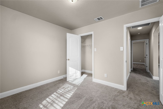 unfurnished bedroom featuring carpet floors and a closet