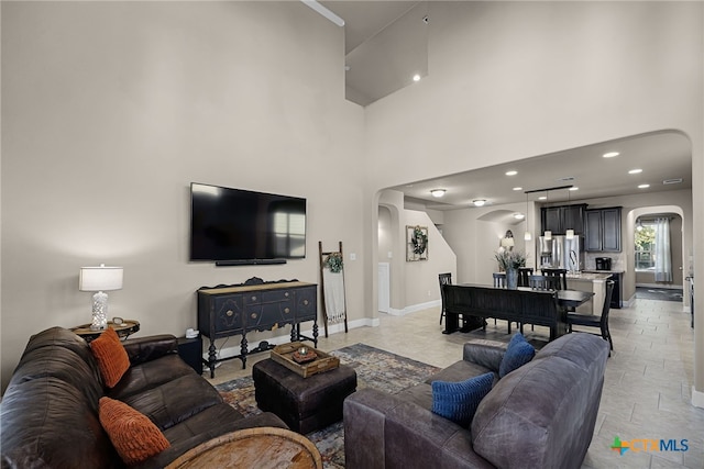 living room with a towering ceiling