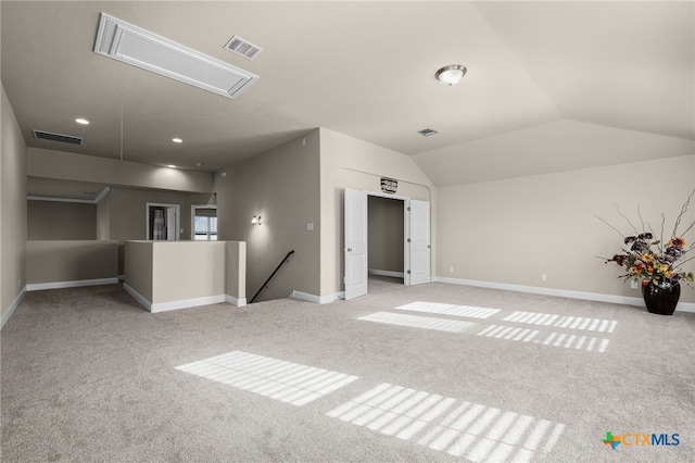 unfurnished living room featuring light carpet and lofted ceiling