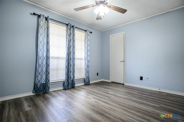 empty room featuring ornamental molding, a textured ceiling, dark wood-type flooring, and ceiling fan